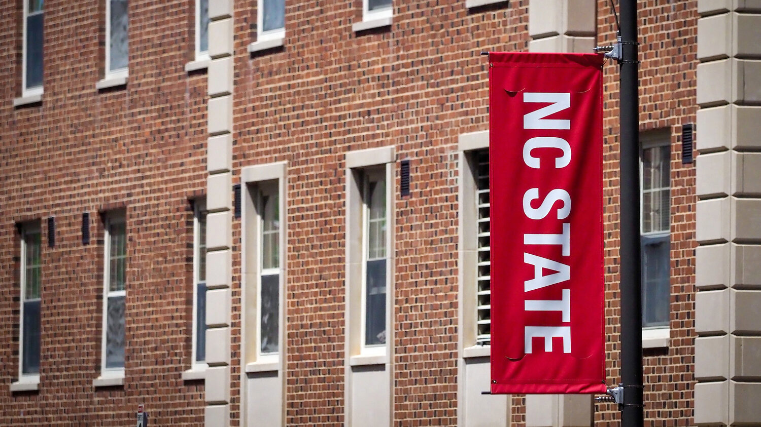 NC State Banner in Front of Tucker Residence Hall