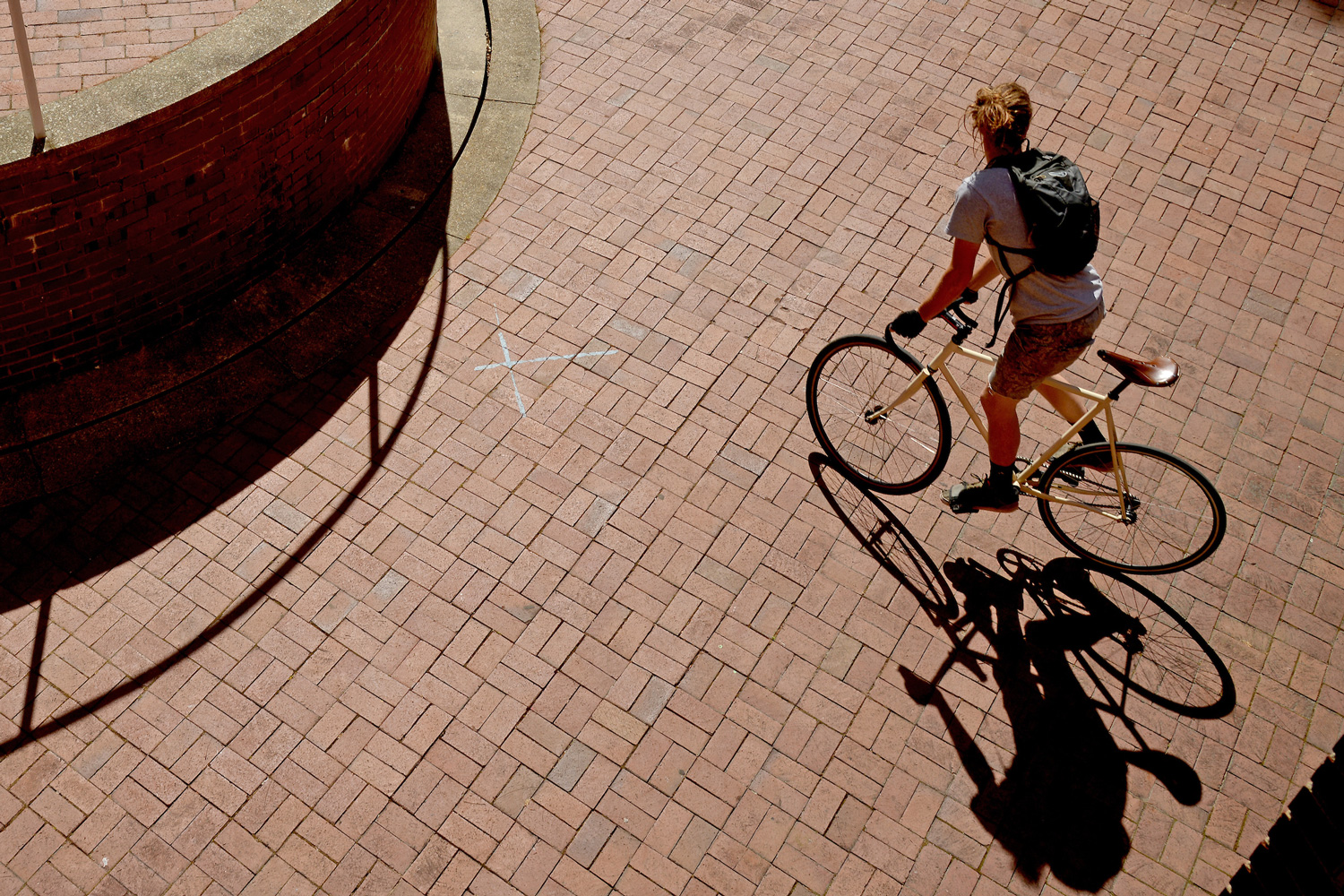 Biking on Bricks outside Kamphoefner Hall